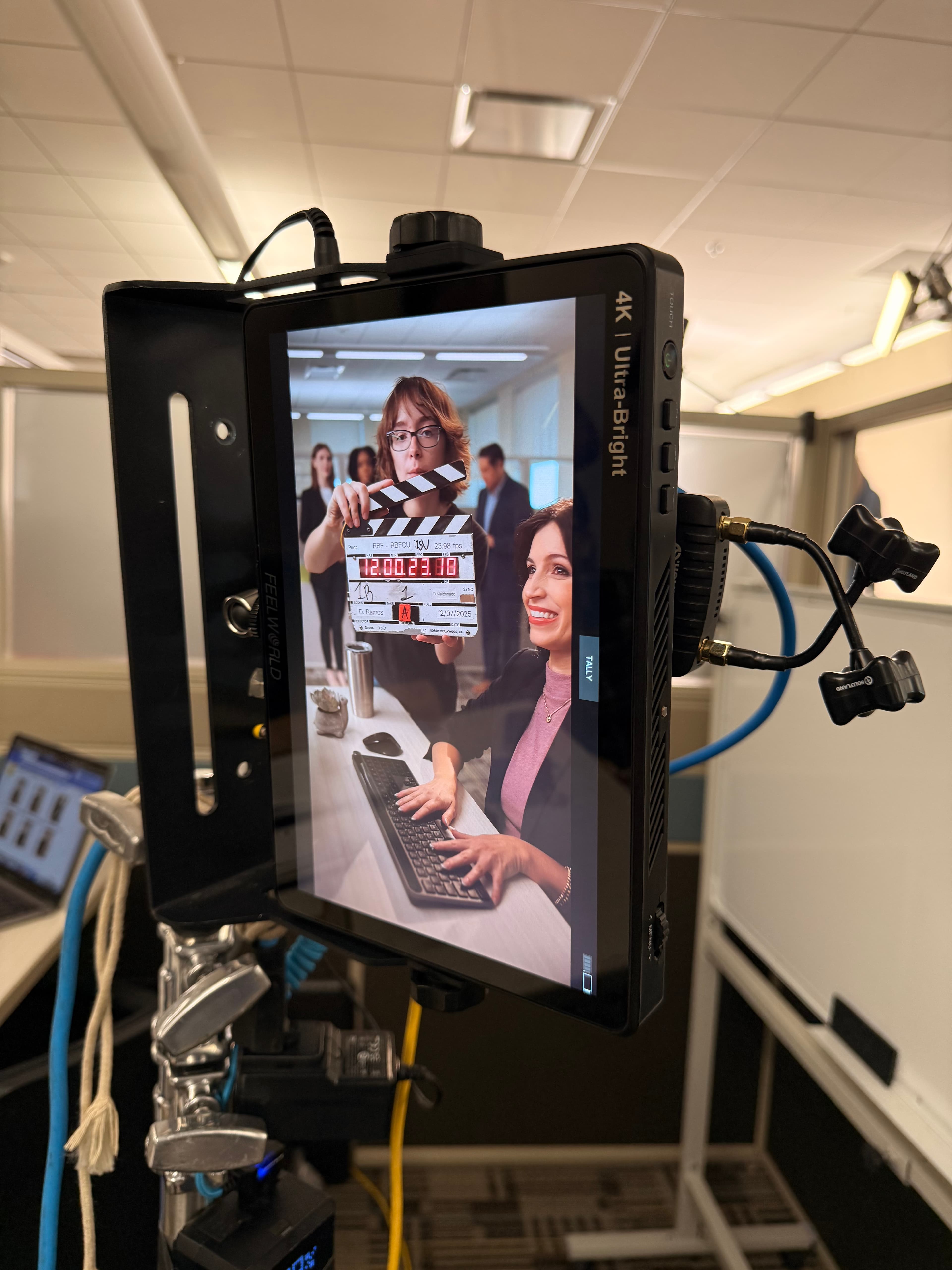 Vertical corporate campaign framing on a production monitor