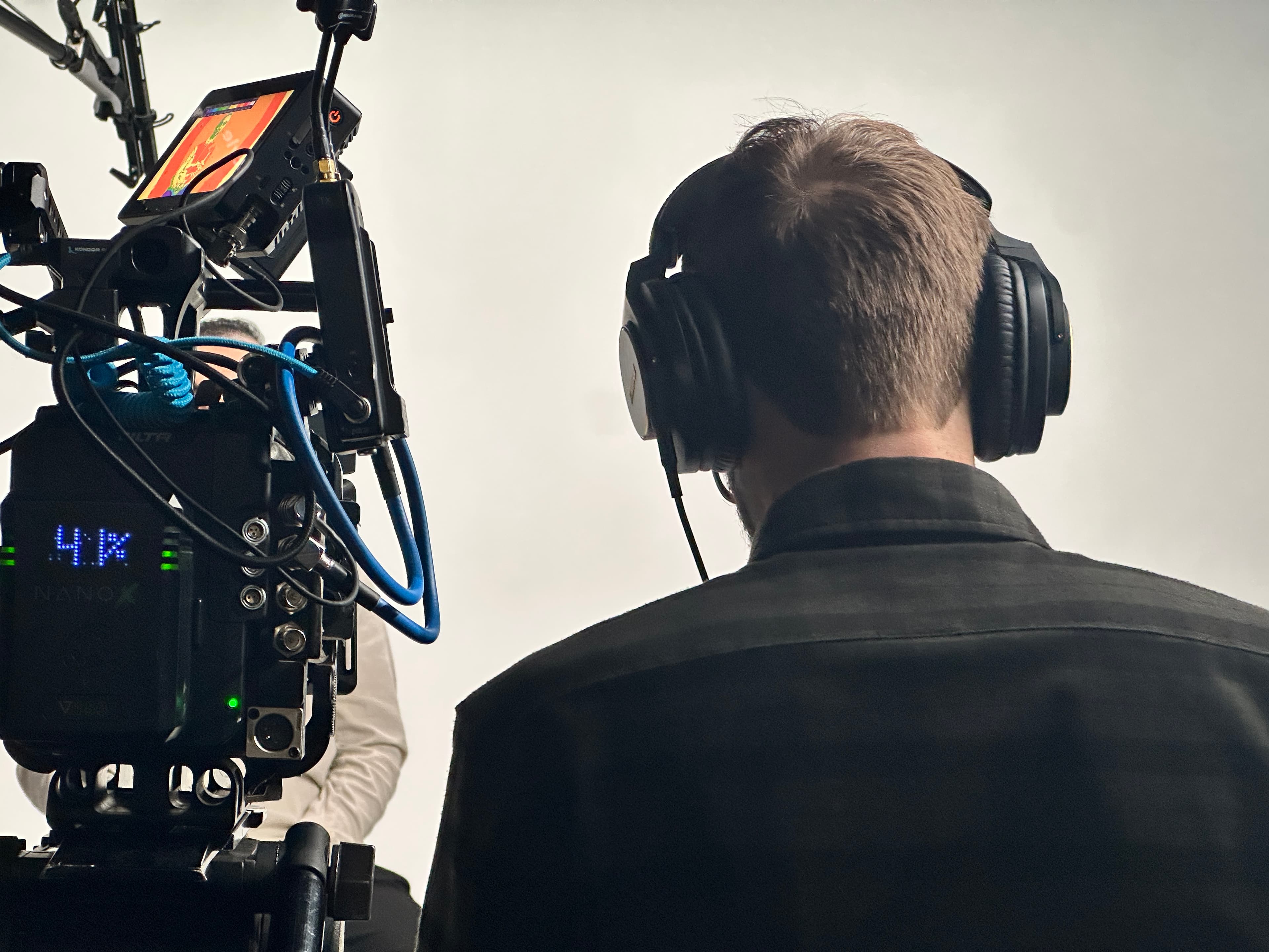 Camera operator filming on the Media Bar studio stage